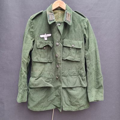 a green jacket with a badge on the chest