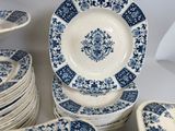 many blue and white plates stacked on top of each other