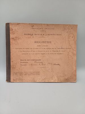 an old book sitting on top of a table next to a white wall