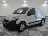a small white van that is parked in a room