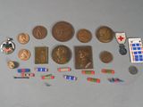a lot of coins, pins, pins and other items on the table