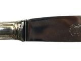 an image of a knife with a wooden handle