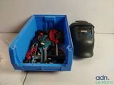 a blue container filled with assorted items next to a meter