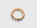 a close up of a gold ring on a white surface
