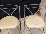 two chairs sitting next to each other on a tile floor
