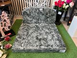 a black and white couch sitting on a green carpet