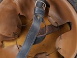 an image of a helmet with a leather strap on it