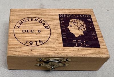 a small wooden box with a stamp on it