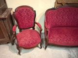 two red chairs sitting next to each other in a room