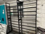 a room with a rack of beer kegs and a soda machine