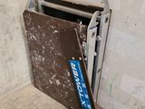 a metal door that is open in the corner of a room