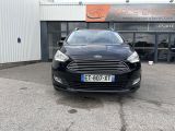 the front of a black ford fiesta parked in front of a building