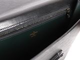 the inside of a green purse with a zipper open