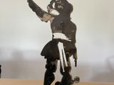 a statue of a man holding a sword on a table