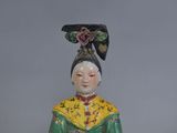 chinese figurine of a woman in a green and yellow dress