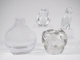 three clear glass vases sitting next to each other on a white surface