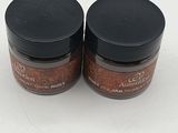 two small jars of food sitting on top of a white surface