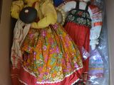 two dolls in a box that are sitting on the floor