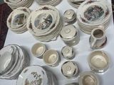 many plates and bowls and cups on the table