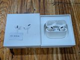 an apple airpods are sitting in a box on a wooden table