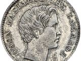 une pièce de monnaie en argent portant un visage de femme