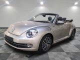 a picture of a silver volkswagen beetle convertible parked on a checkered floor