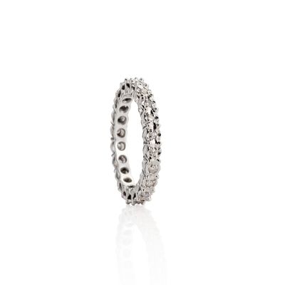 a close up of a diamond ring on a white surface