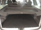 the back of a car with the trunk open and the seats folded down