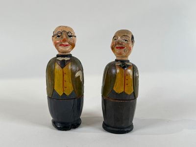 two figurines of a man and a woman standing next to each other
