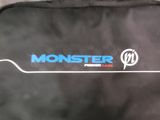 a black bag with a blue monster logo on it