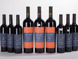 six bottles of red wine are lined up in a row