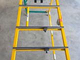 the table is made of metal and has a yellow frame on it