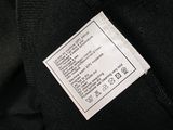 a label on the back of a black sweater