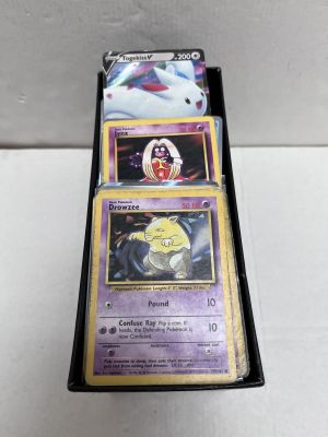a close up of a box of pokemon cards on a table