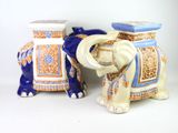 pair of blue and white ceramic elephants sitting next to each other on a white surface