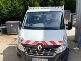 a white van parked in a parking lot with a man standing next to it