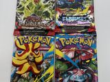 quatre paquets de cartes à collectionner Pokémon