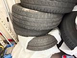 four tires stacked on top of each other in a pile