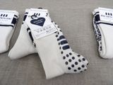 three pairs of white socks with black polka dots on them