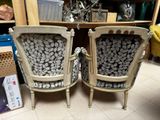 two chairs sitting next to each other in a room