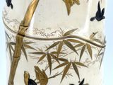 a white vase with gold and black designs on it