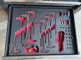 many tools in a tool box on the floor