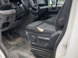 the interior of a white truck with the door open and the driver ' s seat down