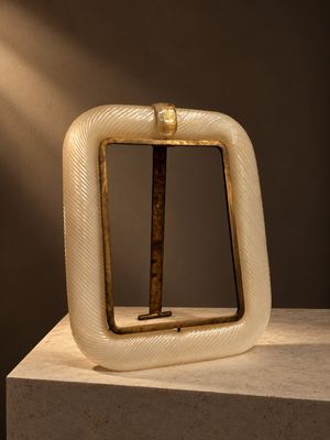 sculpture représentant un objet de forme carrée d'où sort un bâton en bois sur le côté