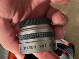 a person holding a camera lens in their hand
