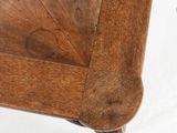 a close up of a wooden chair with a wooden seat