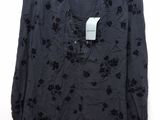 the shirt is black and has black flowers on it