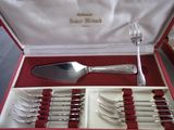 silverware in a red box with red linings and a knife and fork