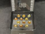 an image of a box with a bunch of gold pieces in it