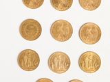 several gold coins are arranged in a row on a white surface